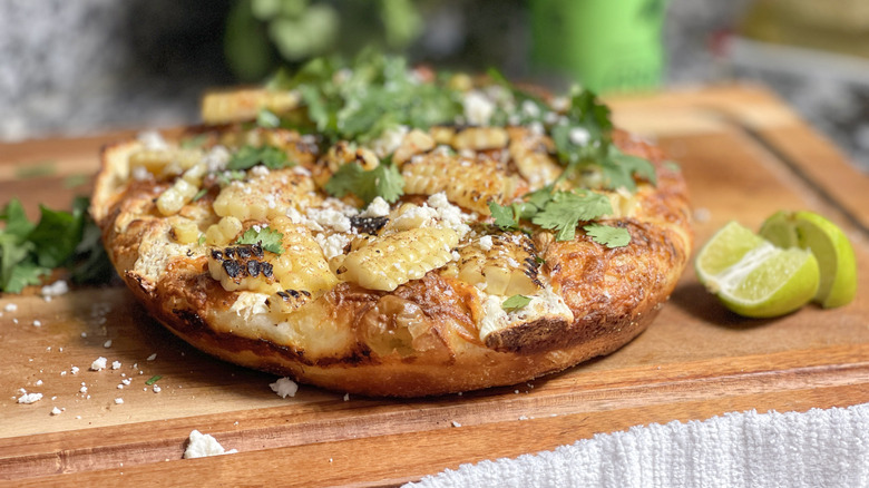 cheesy elote stret corn pizza on cutting board