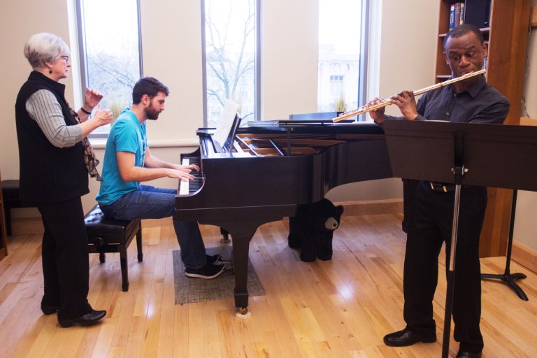 Faculty working with a pianist and flutist. 