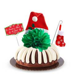 Holiday decoration with Santa hat and a stocking on a Bundt Cake