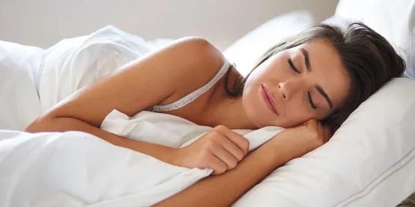 woman sleeping peacefully in bed bug free bed